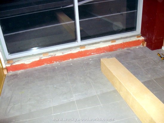 End stop blocks secured to wall